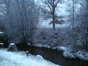 Snow falling on the river