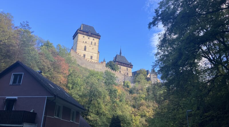 Karlstejn at the end of the hiking trail, above some houses
